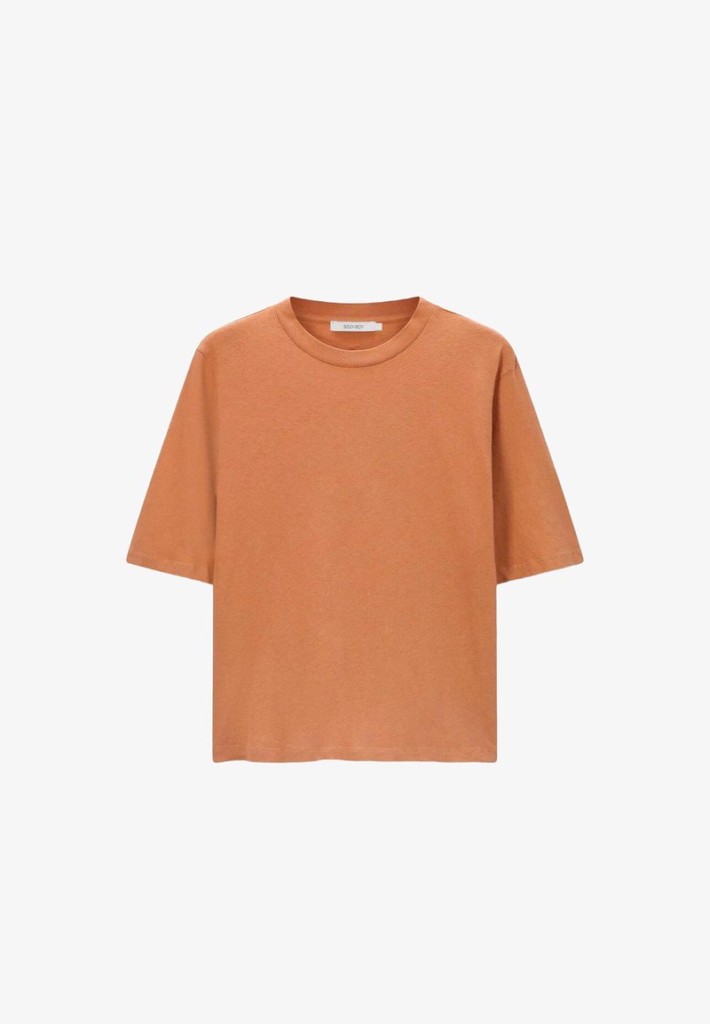 T-shirt à manches courtes en orange rouille, en coton doux, avec un col rond et une coupe décontractée, sans logos visibles.