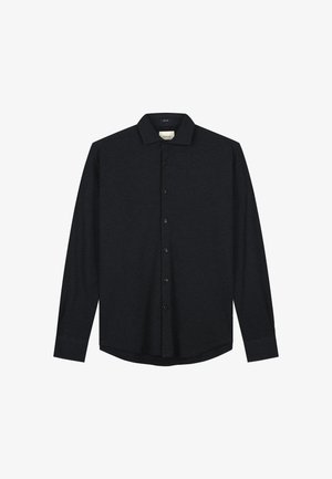 Mørk langermet skjorte med knappestolpe laget av mykt stoff. Har kragehals og en lett buet kant, med en subtil logo.