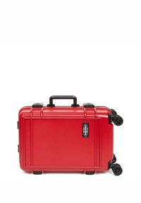 Red hard-shell suitcase with a textured surface, a top handle, and four black wheels. Features a brand logo on the side.