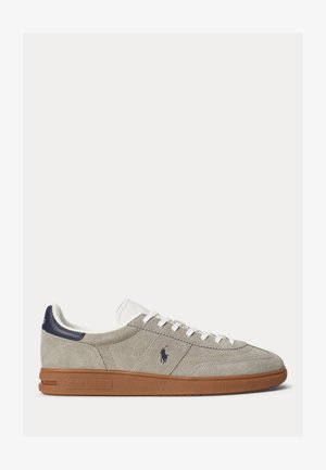 Low-top grey suede sneaker with white laces, navy heel tab, brown rubber sole, and Polo Ralph Lauren logo on the side.