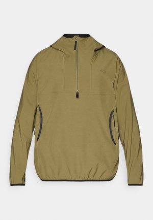 Khaki pullover jacket with a half zip, hood, and elastic cuffs. Features black accents and side zip pockets. Lightweight, smooth texture.