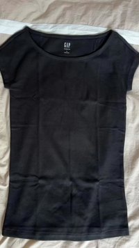 Black cotton T-shirt with a crew neck, short sleeves, and a fitted design. Features GAP branding on the label at the neckline.