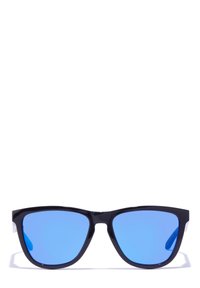 Black plastic sunglasses with blue reflective lenses, angular cat-eye shape, clear side accents, and a minimalist design.