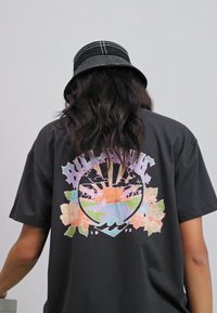 Black t-shirt with a large multicolored graphic on the back, depicting a tropical scene with flowers, waves, and sun rays.