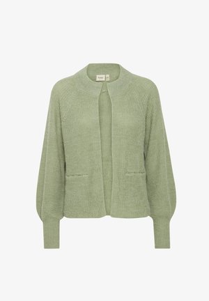 Vaaleanvihreä neuletakki, jossa on pyöreä pääntie, auki oleva etuosa, kaksi taskua ja teksturoitu neulontakangas. Ominaisuuksina pitkät, hieman puffimaiset hihat.