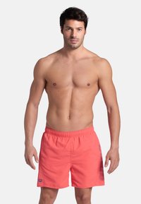 Costumi da bagno da uomo color corallo con cintura elastica, dotati di logo e stampa grafica sul lato. Realizzati in tessuto leggero.