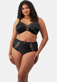 Ensemble de lingerie noire comprenant un soutien-gorge balconnet avec un bord en dentelle et une culotte taille haute. Les deux pièces comportent des panneaux en maille transparente et des accents décoratifs.