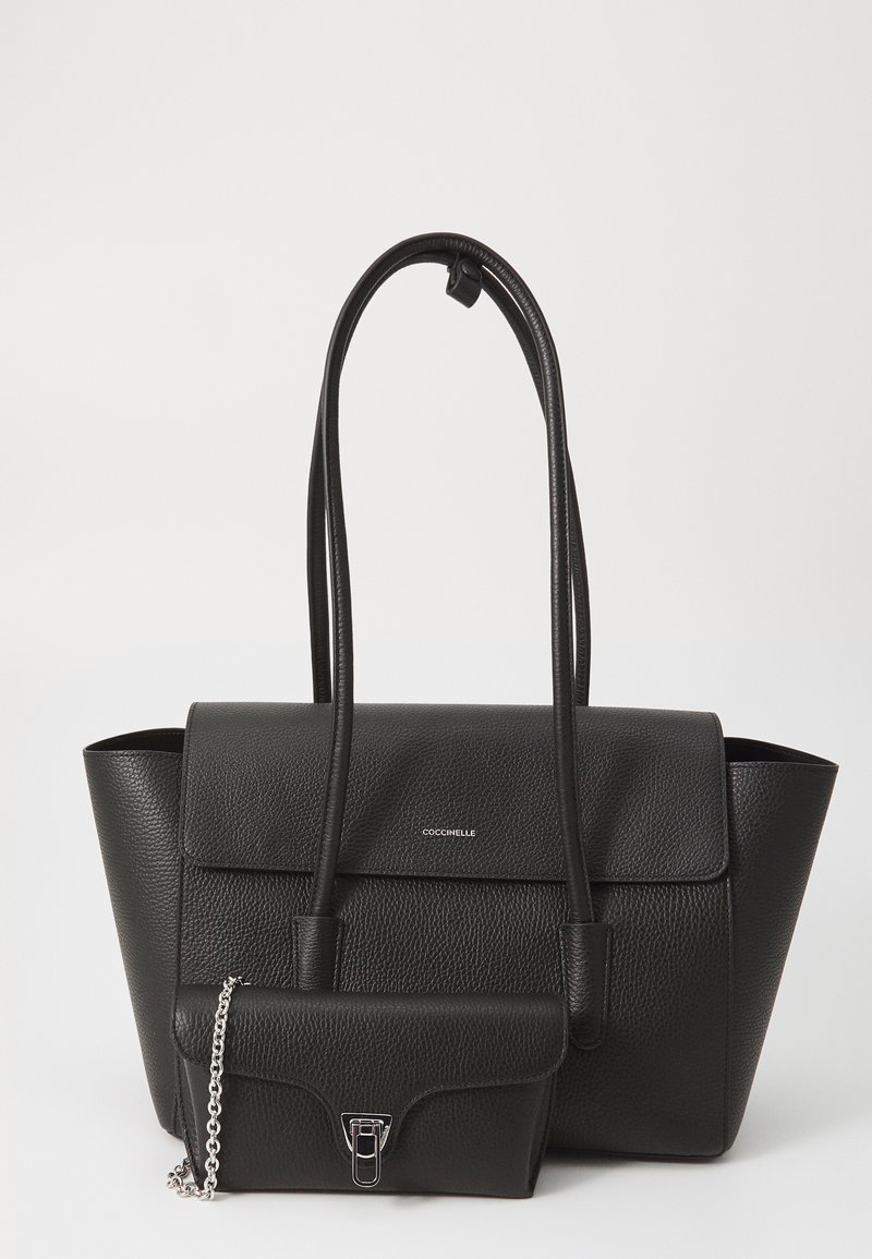 Sac fourre-tout en cuir noir avec une finition texturée, doté de deux longues poignées, d'une fermeture à rabat et d'une petite poche détachable avec une chaîne.
