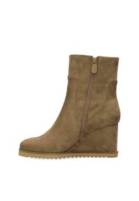 Brown suede wedge boots with a side zip closure, smooth texture, and a scalloped outsole. Ankle height with a sleek, tapered design.