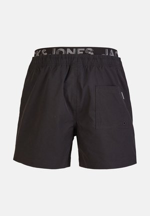 Black swim shorts with an elastic waistband featuring a logo. They have a side pocket with a button detail and a smooth texture.