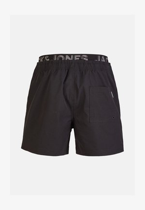 Shorts de bain noirs avec une taille élastique arborant un logo. Ils possèdent une poche latérale avec un détail à bouton et une texture lisse.