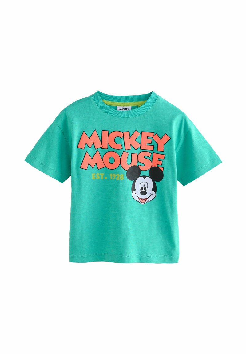 Grøn bomulds t-shirt med korte ærmer, der har et stort grafisk billede af Mickey Mouses ansigt og teksten "MICKEY MOUSE EST. 1928."
