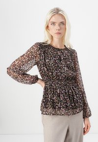 Svart blommig blus med genomskinliga långa ärmar, samlad halsringning och midja. Har ett flerfärgat mönster med rosa, lila och gula accenter.