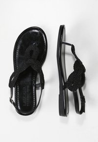 Sorte flade sandaler med flettede stropper og en glat sål. Minimalistisk design med en justerbar ankelrem for en sikker pasform.