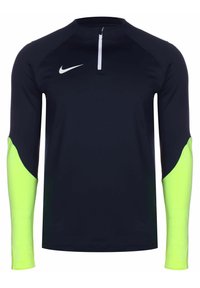 Marineblauw sportshirt met lange mouwen en halve rits kraag, met neon groene gestructureerde mouwen en contrasterend wit logo op de borst.