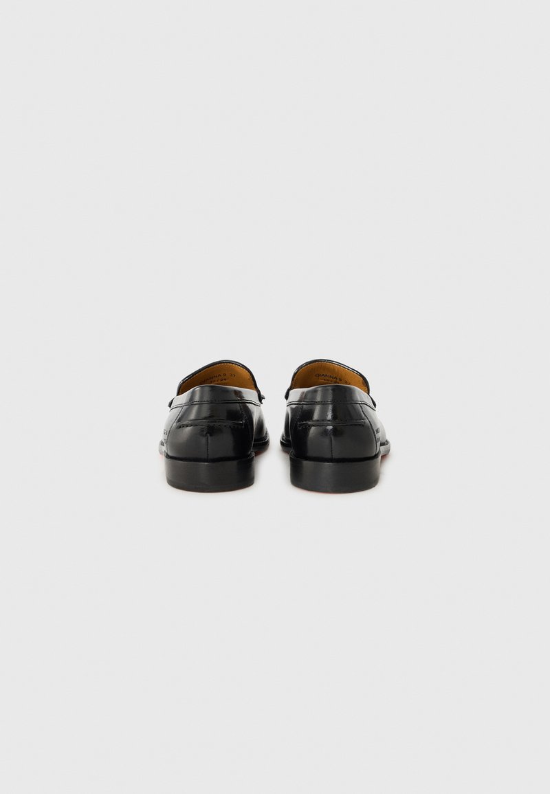 Mocassins en cuir noir avec une finition lisse, un talon bas et une doublure intérieure beige. Design simple avec un matériel minimal et des détails de couture.
