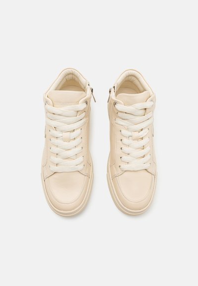 Beige high-top sneakers made of smooth leather with white laces and side zippers; rounded toe and padded collar for comfort.
