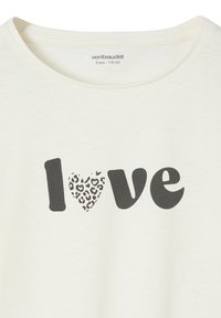 Cream-colored T-shirt with a round neckline featuring black "love" text, and a heart in a leopard print pattern.