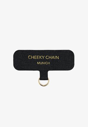 Black fabric keychain attachment with a rectangular shape, featuring "CHEEKY CHAIN MUNICH" in gold lettering and a gold ring hardware.