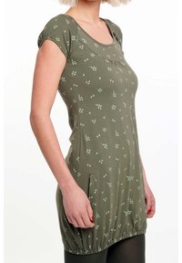 Grüne Tunika mit grünen Blattmustern, kurzen Ärmeln, Rundhalsausschnitt und elastischem Saum. Verfügt über seitliche Taschen für mehr Funktionalität.