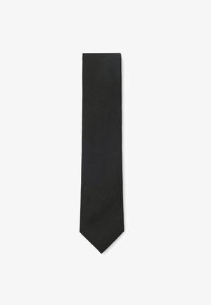 Sort diagonalt striped slips med en klassisk spids spids på en hvid baggrund.