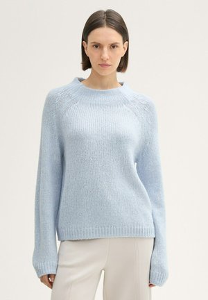 Suéter de punto azul claro con cuello redondo, mangas largas y puños y dobladillo acanalados. La textura es suave y ligeramente holgada.