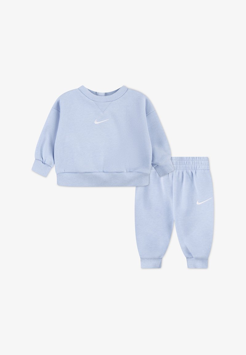 Light blue cotton sweatshirt and matching sweatpants. Features include ribbed cuffs and waistband, with a white Nike logo on each piece.