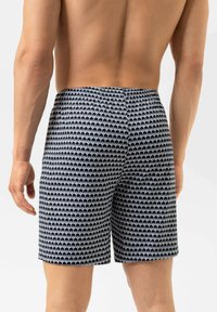 Heren zwembroek in marineblauw met wit olifantenpatroon. Gemaakt van lichtgewicht materiaal, met een elastische tailleband voor comfort.