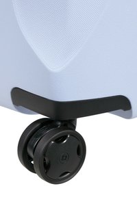 Light blue suitcase with textured surface, black accents, and a black, multi-directional wheel at the base for easy maneuverability.