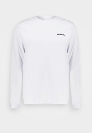 Valge pikakäistega t-särk, mis on valmistatud puuvillast. Omab ümmargust kaelust ja väikest musta "patagonia" logo vasakul rinnaülal.