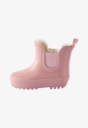 Stivale da pioggia rosa in gomma per bambini, con suola strutturata, pannelli laterali elastici e morbida fodera in pile bianca visibile in cima.