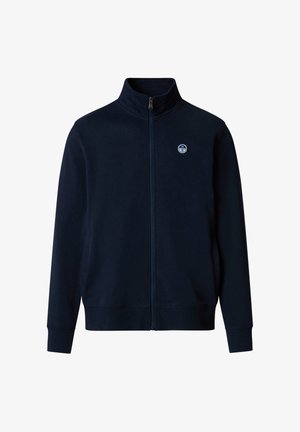 Giacca blu navy con zip integrale, collo alla coreana, polsini e orlo a coste, e un piccolo logo a forma di bussola rotonda sul petto a sinistra.