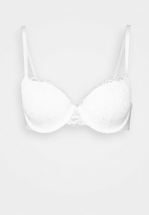 White lace bra featuring padded cups, adjustable straps, and scalloped edges. Soft texture with a floral pattern throughout.