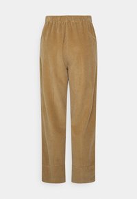 Bruna kordbyxor med vida ben, med resårmidja och subtil vertikal ribbtextur. Inga synliga fickor.