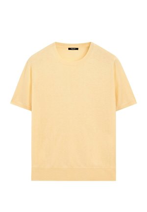 Maglietta a maniche corte con collo tondo in beige chiaro con collo e orlo a coste, mostrata su sfondo bianco.