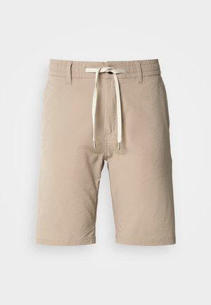 Beige shorts made of textured fabric with an elastic waistband, featuring a drawstring and metal ends, with a straight cut and hem.