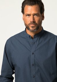 Dunkelblaue Button-up-Bluse mit kleinen weißen Punkten, kragenloser Ausschnitt und strukturierter Stoff, mit schwarzen Knöpfen an der Vorderseite.