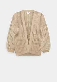 Beige neulottu neuletakki, jossa on avoimen kudoksen kuvio, väljä malli ja resorit hihansuissa. Siinä on syvä V-kaula-aukko, eikä siinä ole kiinnityksiä.