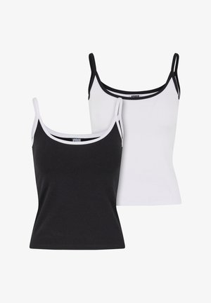 Deux camisoles en noir et blanc. Fabriquées en tissu doux, avec des bretelles fines et un passepoil contrasté le long de l'encolure et des emmanchures.