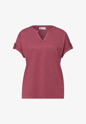 Short-sleeve dusty rose blouse with V-neckline and rolled cuff sleeves secured by small buttons, made of soft textured fabric.