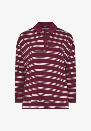 Czerwono-brązowa polo z długim rękawem. Posiada kołnierzyk zapinany na guziki oraz białe poziome paski. Wykonana z teksturowanej tkaniny.