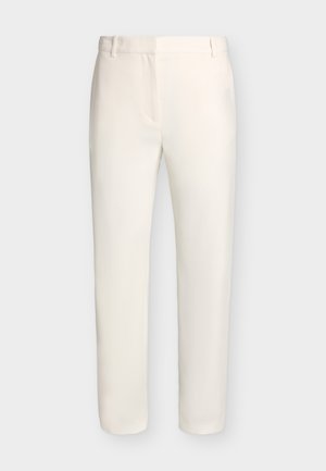 Λευκό παντελόνι ραμμένο στο μέτρο με θηλιές για ζώνη και στενή εφαρμογή, παρουσιάζεται σε απλό ανοιχτό φόντο.