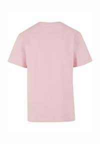 Short-sleeved t-shirt in light pink cotton. Straight cut with a round neck. The fabric has a smooth texture, no visible patterns or accents.