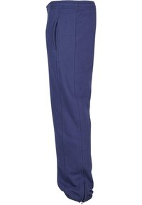 Navyblaue Sweatpants mit elastischem Bund, seitlichen Taschen und Reißverschlüssen an den Knöcheln. Hergestellt aus weichem, strapazierfähigem Stoff mit glatter Textur.