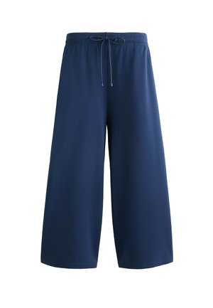 Laivansiniset leveälahkeiset housut, jotka on valmistettu pehmeästä materiaalista. Housuissa on joustava vyötärö, jossa on kiristysnaru, eikä näkyviä taskuja tai kuvioita.