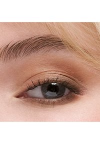 Close-up of a grey eye with curled lashes, natural light brown eyeshadow, and a well-groomed dark brown eyebrow with blonde hair nearby.
