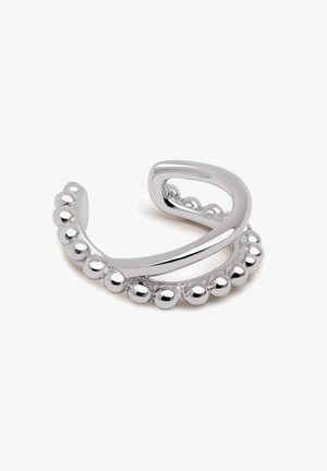 Siverfärgad metallring med en böjd ring med en rad sfäriska pärlor. Slät yta med polerad finish, öppen design för justerbarhet.