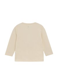 Langsleeve t-shirt in crème. Zacht, lichtgewicht stof met een ronde halslijn. Eenvoudig ontwerp, geen patronen of accenten. Naadloze achterkant.
