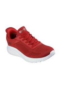 Red athletic shoe with mesh upper, laces, and white rubber sole. Features textured design and logo on side.