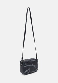 Black rectangular crossbody bag with adjustable strap, featuring light gray "Emporio Armani" script pattern and a gold zipper closure.